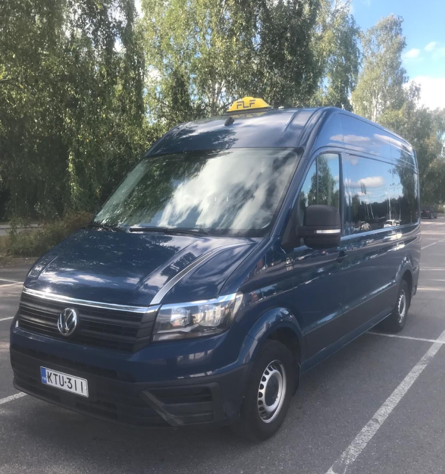 Dark blue accessible Volkswagen Crafter VIP minibus taxi